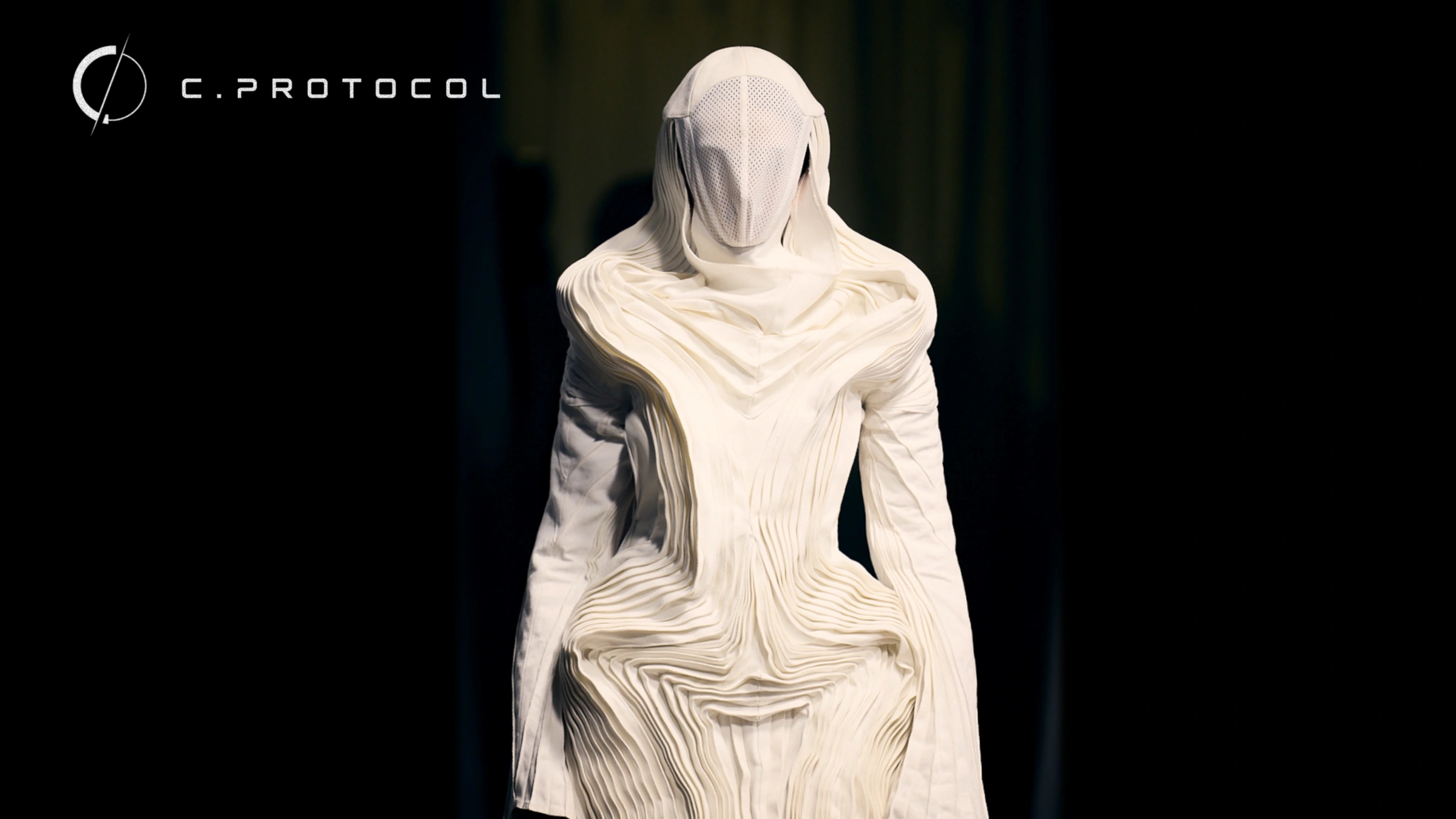 C.PROTOCOL — white sculptural pleated garment with veiled face
