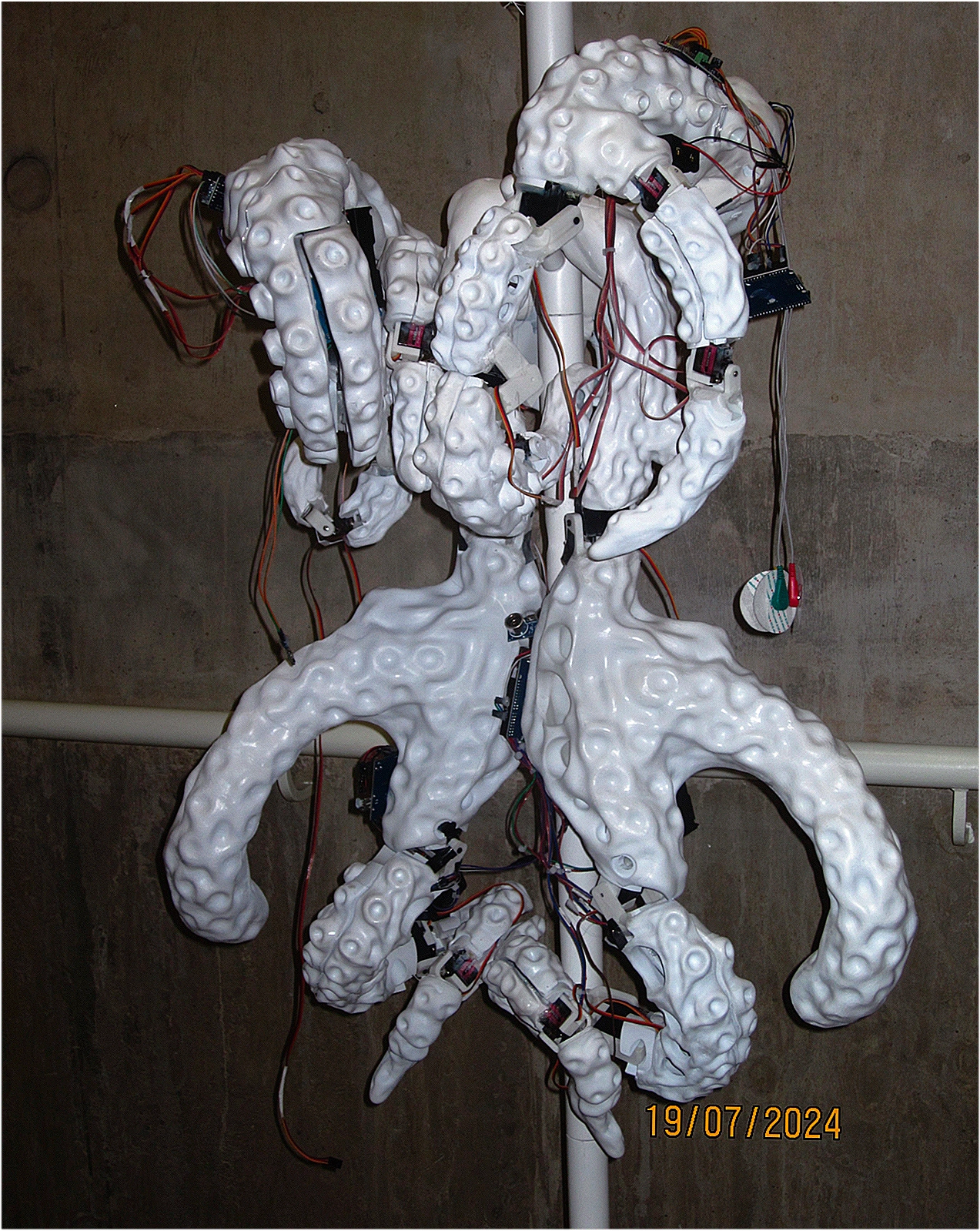 Close view of the physical white wearable structure with mechanical joints and wiring