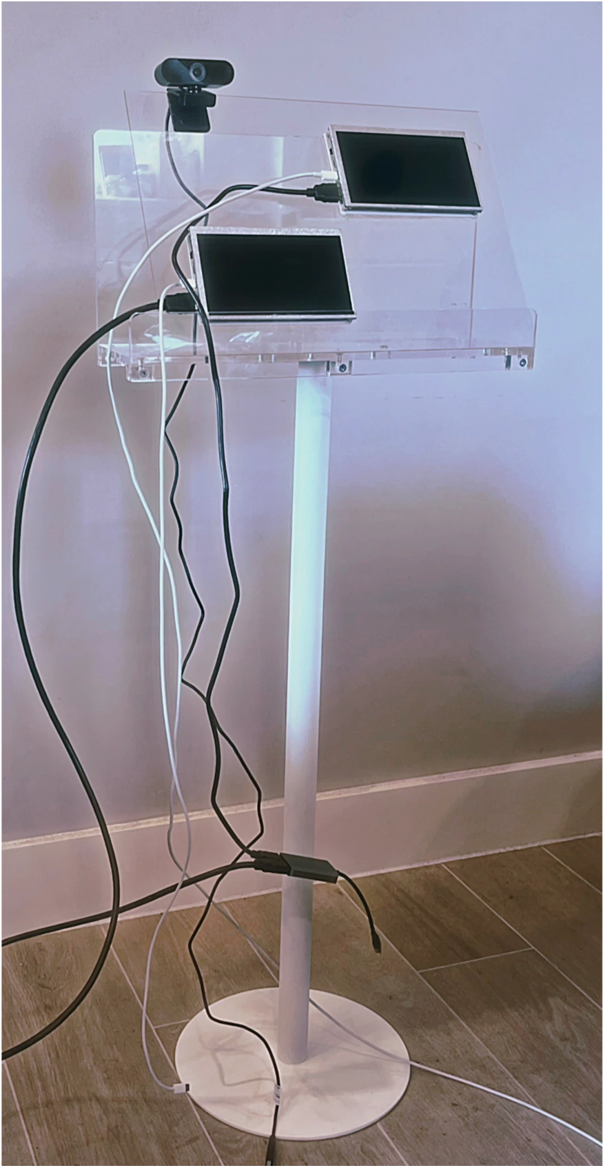 Physical installation with camera, two screens, transparent supports and wiring